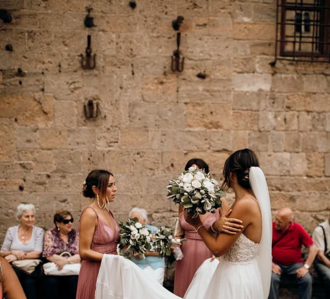 Bride wears Justin Alexander wedding dress with white flower bouquet