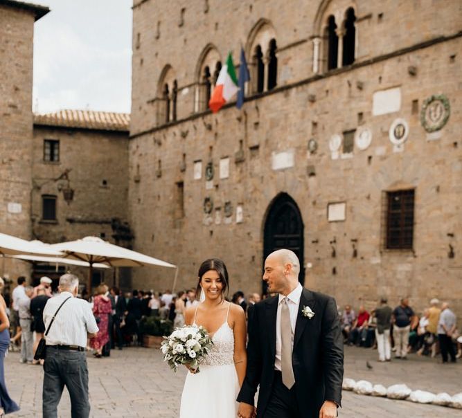 Bride wears Justin Alexander wedding dress with white flower bouquet