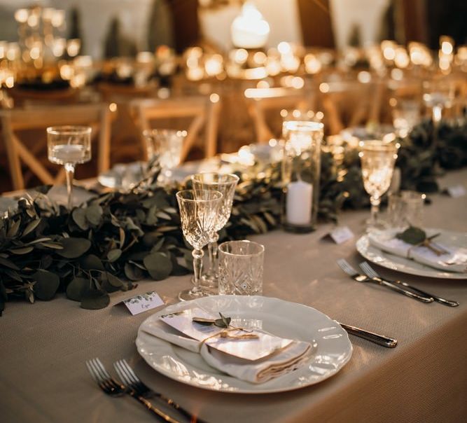 Wedding table decor with foliage table runner and candles