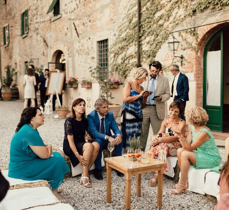 Wedding guests mingle at small Italian wedding