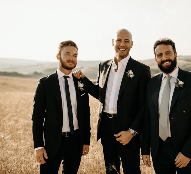 Groom and groomsmen in black wedding suits