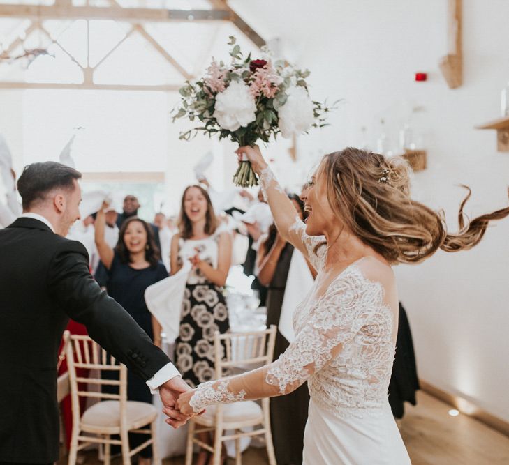 Bride &amp; Groom Wedding Breakfast Entrance | Bride in Madison James Bridal Gown | Groom in Tuxedo | Millbridge Court, Surrey Wedding with DIY Decor, Foliage &amp; Giant Balloons | Nataly J Photography