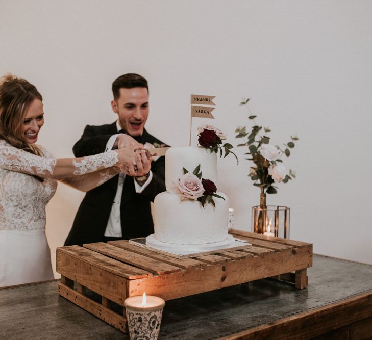 Cutting The Wedding Cake | Bride in Madison James Bridal Gown | Groom in Tuxedo | Millbridge Court, Surrey Wedding with DIY Decor, Foliage &amp; Giant Balloons | Nataly J Photography