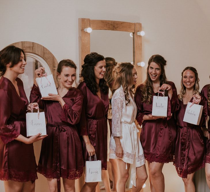 Bridesmaids in Matching Burgundy Robes with Bridesmaid Gift Bags | Millbridge Court, Surrey Wedding with DIY Decor, Foliage &amp; Giant Balloons | Nataly J Photography