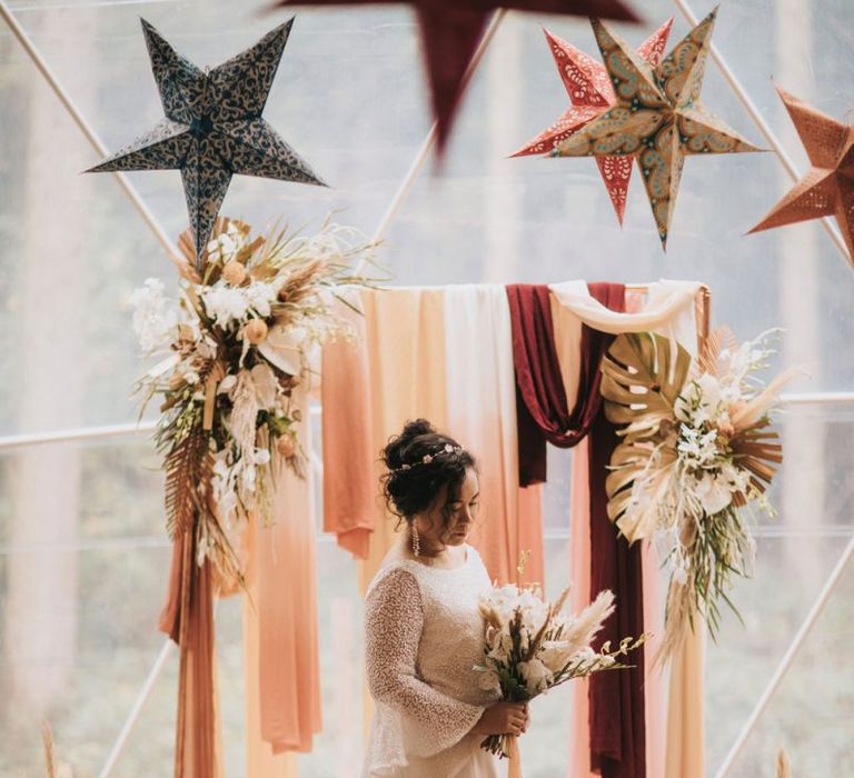 Bride in Sparkly Rolling in Roses Wedding Dress at the Altar in Geometric Dome