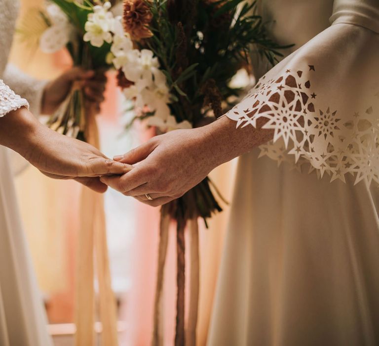 Same-sex Couple Holding Hands in Bell Sleeve Dresses in Geometric Dome