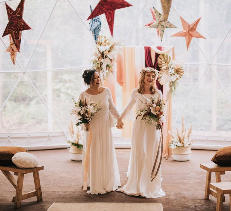 Bohemian Brides Walking Up the Aisle as Wife and Wide in a Geometric Dome