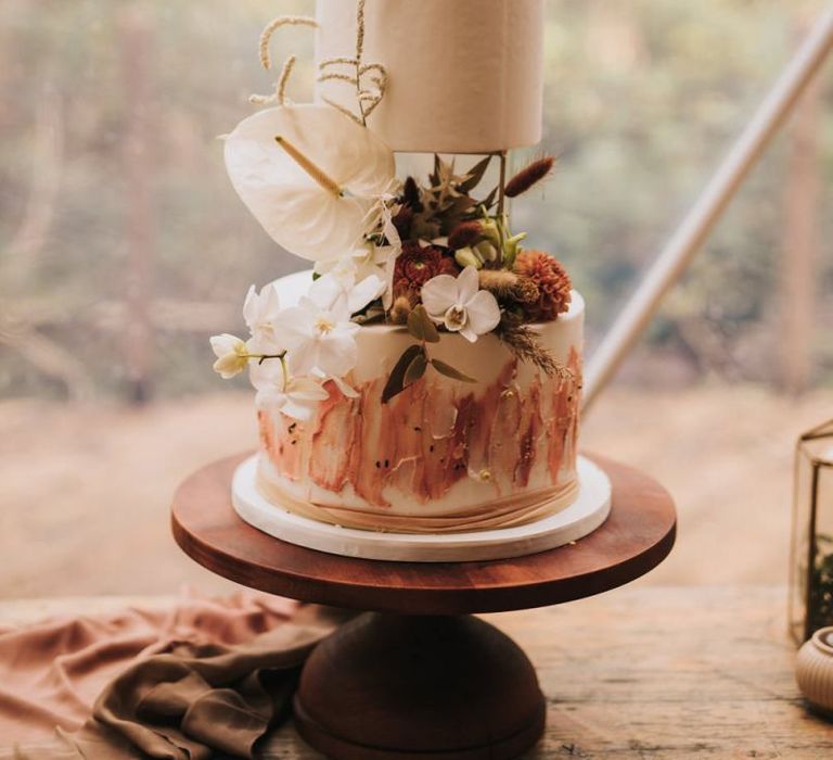 Bohemian Wedding Cake on Wooden Cake Stand in Geometric Dome