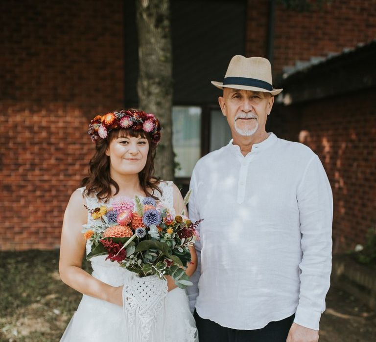 Father of the Bride and Daughter in Lace Wedding Dress with Bright Bouquet and Flower Crown