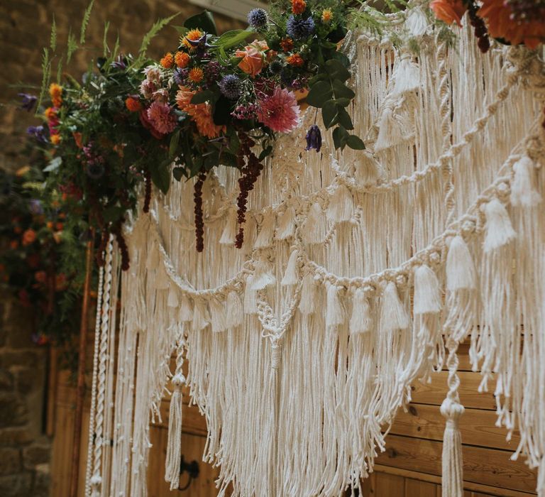 Homemade Macrame Wedding Backdrop with Bright Flower Decor