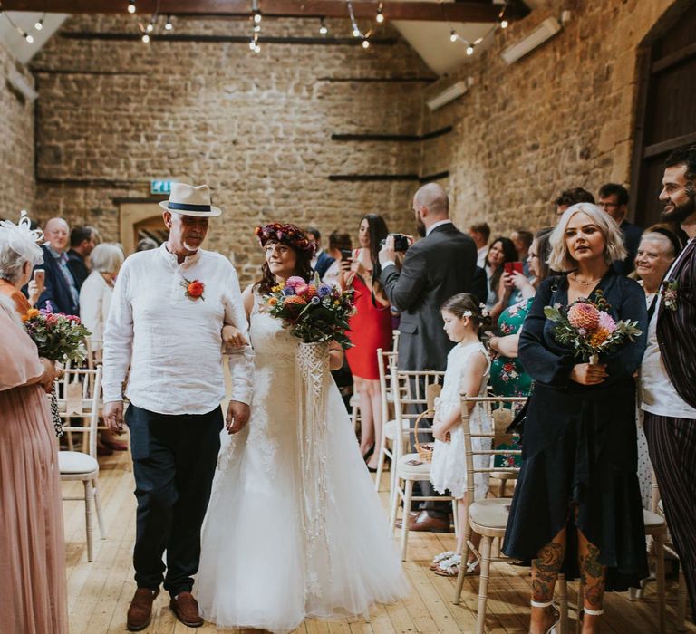 Wedding Ceremony Bridal Entrance with Bride in Lace Wedding Dress and Bright Flower Crown