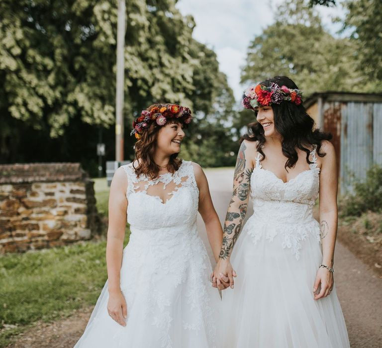 Same Sex Brides in Lace Wedding Dresses and Colourful Flower Crowns