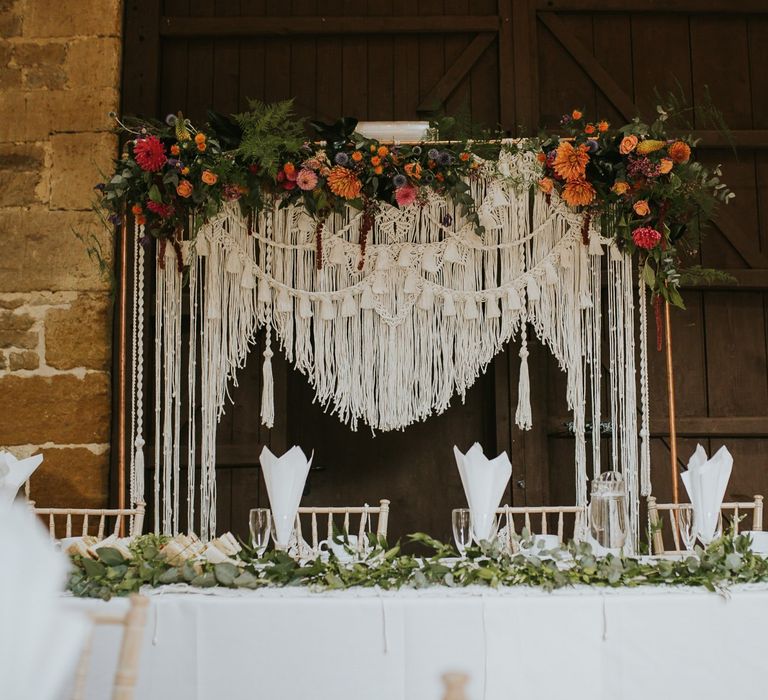 Homemade Macrame Backdrop on Copper Frame with Colourful Wedding Flowers