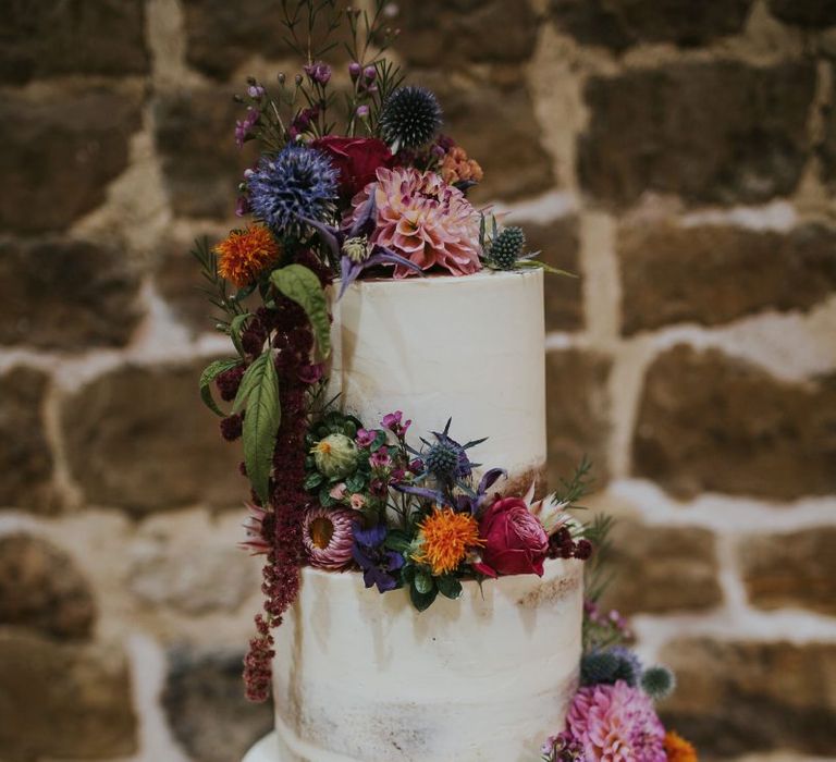 Semi Naked Wedding Cake on a Tree Slice with Colourful Wedding Flowers