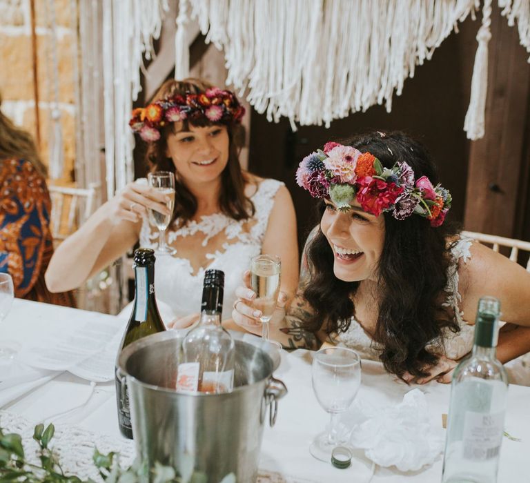 Bride in Homemade Flower Crown Laughing During the Wedding Speeches