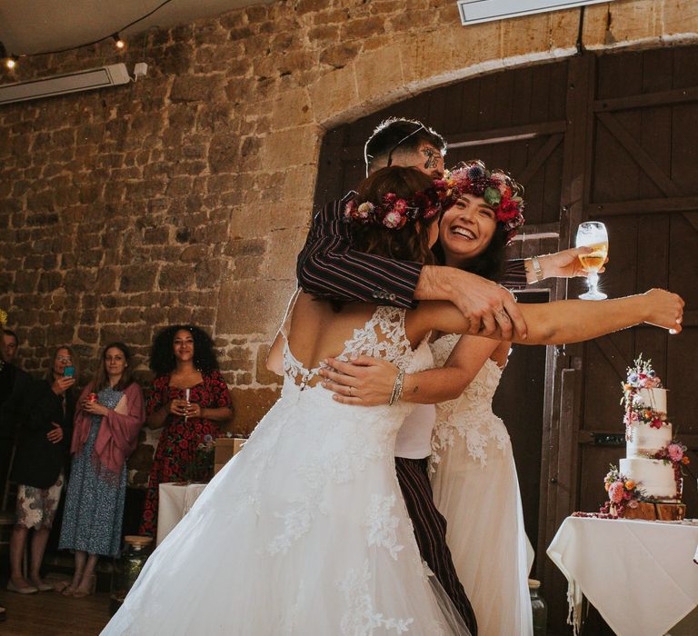 Wedding Guest Embracing the Happy Couple