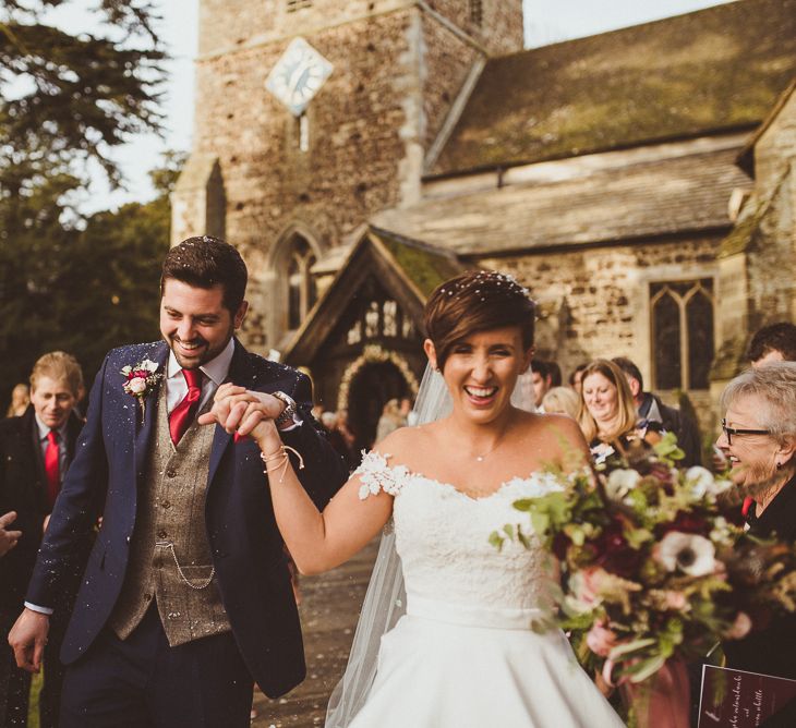 Church Confetti Moment | Bride in Lillian West Bridal Separates | Groom in Navy Suit &amp; Tweed Waistcoat | Burgundy &amp; Gold Winter Wedding at Ramster Hall Weddings, Surrey | Matt Penberthy Photography | John Harris Wedding Films