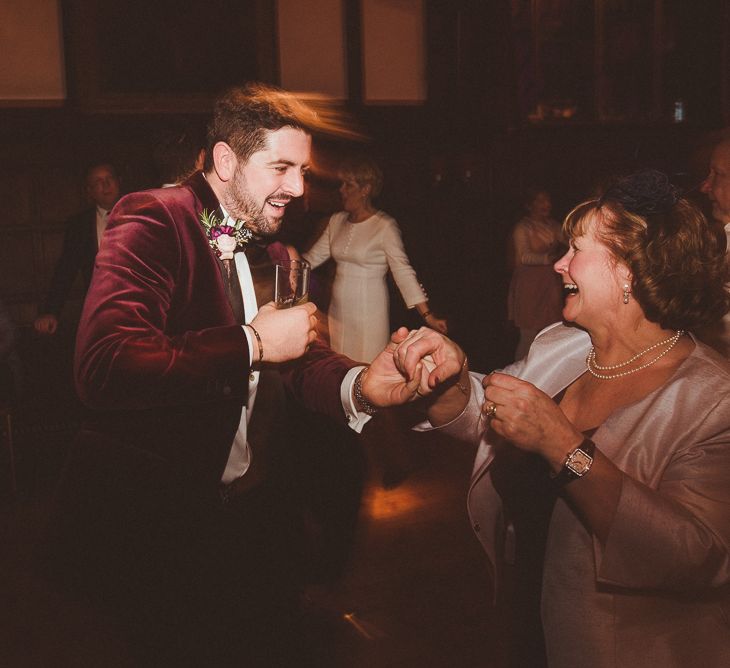 Groom in Velvet Dinner Jacket | Evening Reception Wedding Pictures | Burgundy &amp; Gold Winter Wedding at Ramster Hall Weddings, Surrey | Matt Penberthy Photography | John Harris Wedding Films