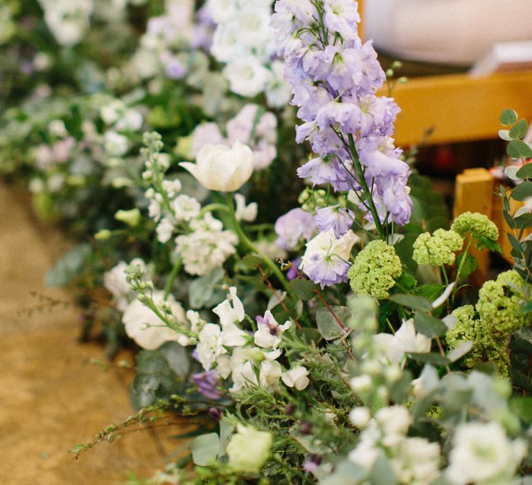 Lilac and white floral aisle runner | Papakata Sperry Tent Wedding at family home | Sassi Holford Dress with added ivory Ostrich feathers to veil | Manolo Blahnik shoes | Images by Melissa Beattie