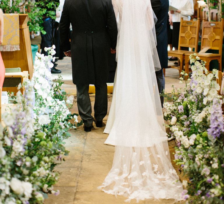 Lilac and white floral aisle runner | Silver Birch trees | Papakata Sperry Tent Wedding at family home | Sassi Holford Dress with added ivory Ostrich feathers to veil | Manolo Blahnik shoes | Images by Melissa Beattie