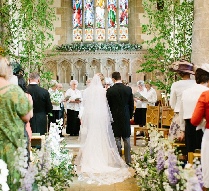 Lilac and white floral aisle runner | Silver Birch trees | Papakata Sperry Tent Wedding at family home | Sassi Holford Dress with added ivory Ostrich feathers to veil | Manolo Blahnik shoes | Images by Melissa Beattie