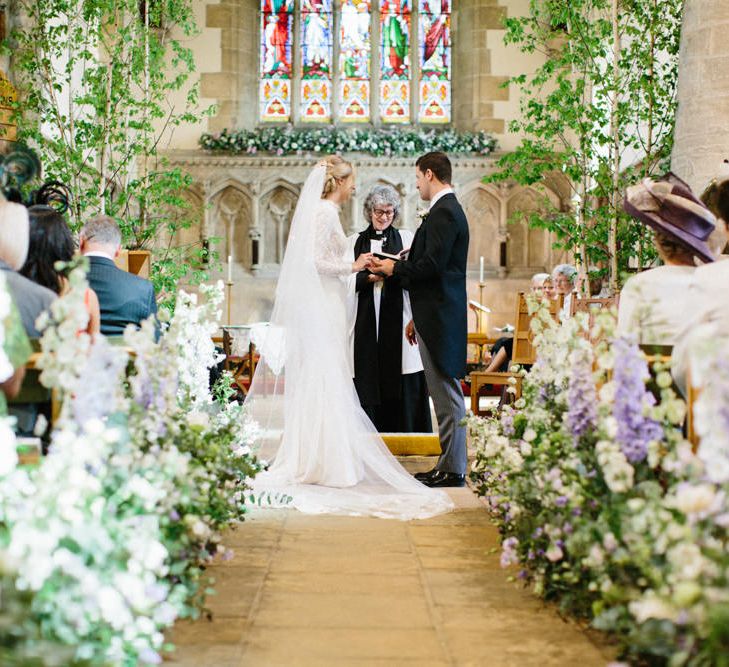 Lilac and white floral aisle runner | Silver Birch trees | Papakata Sperry Tent Wedding at family home | Sassi Holford Dress with added ivory Ostrich feathers to veil | Manolo Blahnik shoes | Images by Melissa Beattie