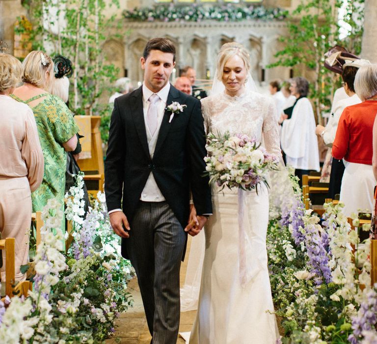 Lilac and white floral aisle runner | Silver Birch trees | Papakata Sperry Tent Wedding at family home | Sassi Holford Dress with added ivory Ostrich feathers to veil | Manolo Blahnik shoes | Images by Melissa Beattie