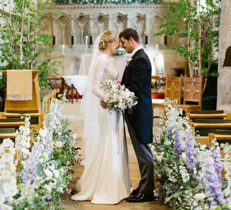 Lilac and white floral aisle runner | Silver Birch trees | Papakata Sperry Tent Wedding at family home | Sassi Holford Dress with added ivory Ostrich feathers to veil | Manolo Blahnik shoes | Images by Melissa Beattie