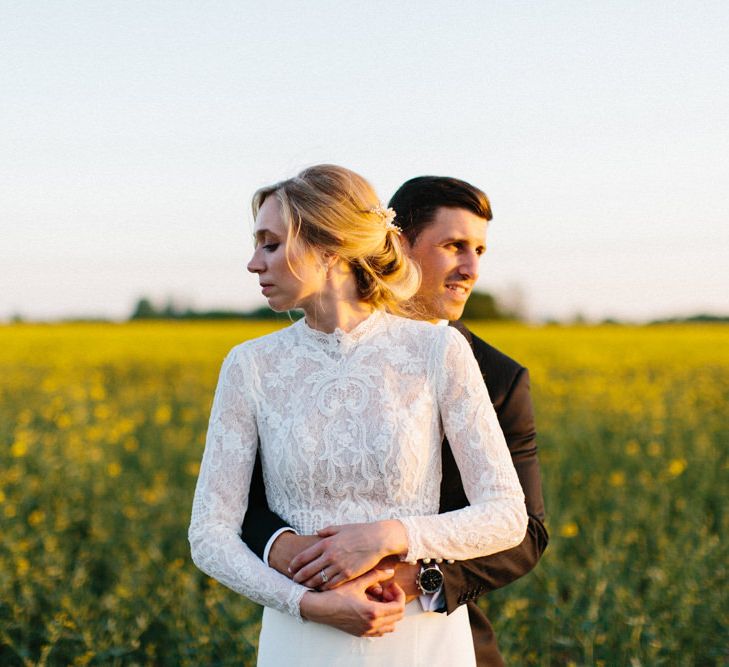 Yellow meadow couple shoot at dusk | Papakata Sperry Tent Wedding at family home | Sassi Holford Dress with added ivory Ostrich feathers to veil | Manolo Blahnik shoes | Images by Melissa Beattie