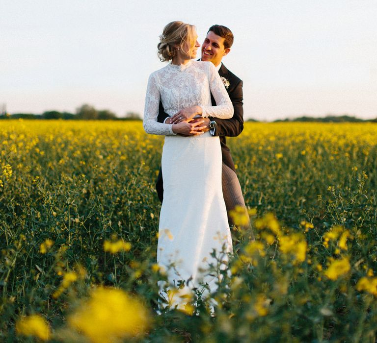 Yellow meadow couple shoot at dusk | Papakata Sperry Tent Wedding at family home | Sassi Holford Dress with added ivory Ostrich feathers to veil | Manolo Blahnik shoes | Images by Melissa Beattie