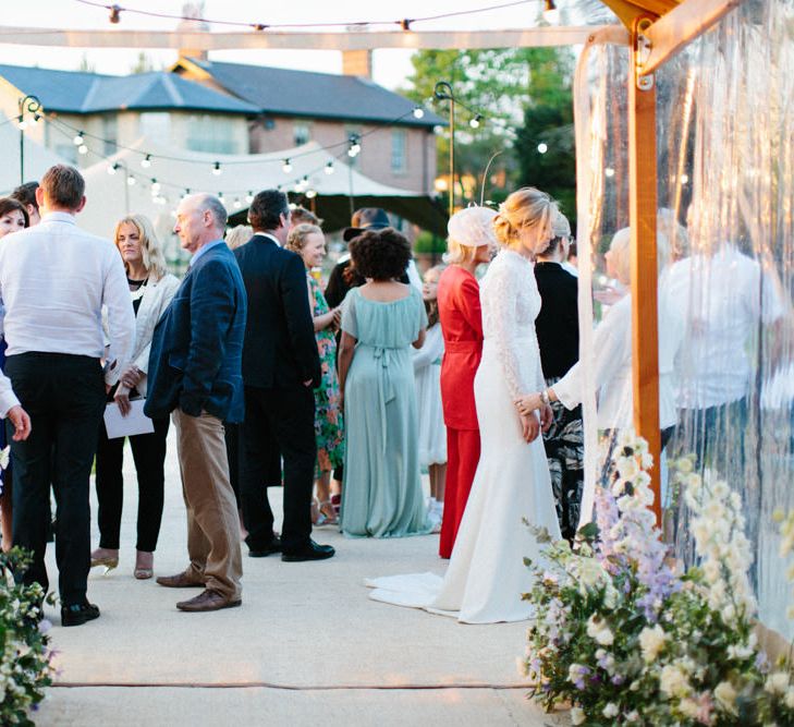 Papakata Sperry Tent Wedding at family home | Sassi Holford Dress with added ivory Ostrich feathers to veil | Manolo Blahnik shoes | Images by Melissa Beattie