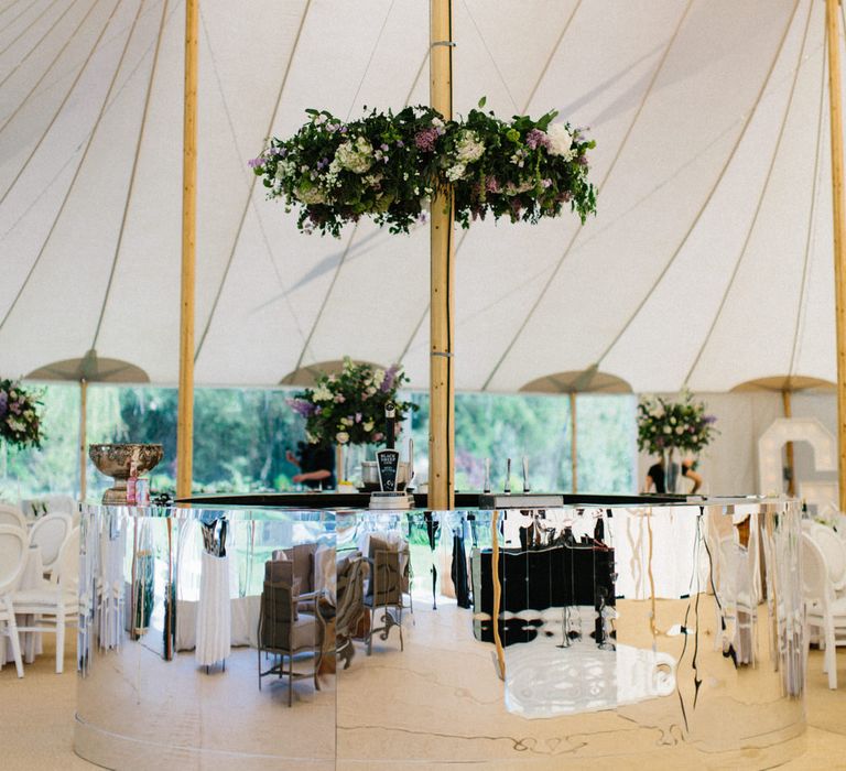 Silver bar and floral wreath | Papakata Sperry Tent Wedding at family home | Sassi Holford Dress with added ivory Ostrich feathers to veil | Manolo Blahnik shoes | Images by Melissa Beattie