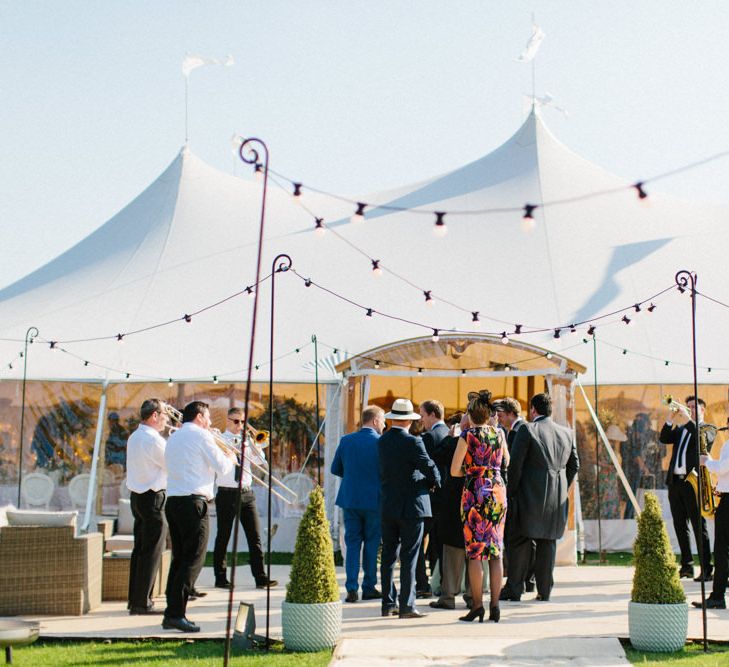 Roaming Band welcoming guests | Papakata Sperry Tent Wedding at family home | Sassi Holford Dress with added ivory Ostrich feathers to veil | Manolo Blahnik shoes | Images by Melissa Beattie