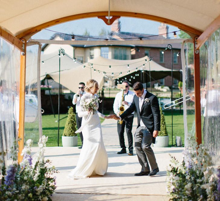 Papakata Sperry Tent Wedding at family home | Sassi Holford Dress with added ivory Ostrich feathers to veil | Manolo Blahnik shoes | Images by Melissa Beattie