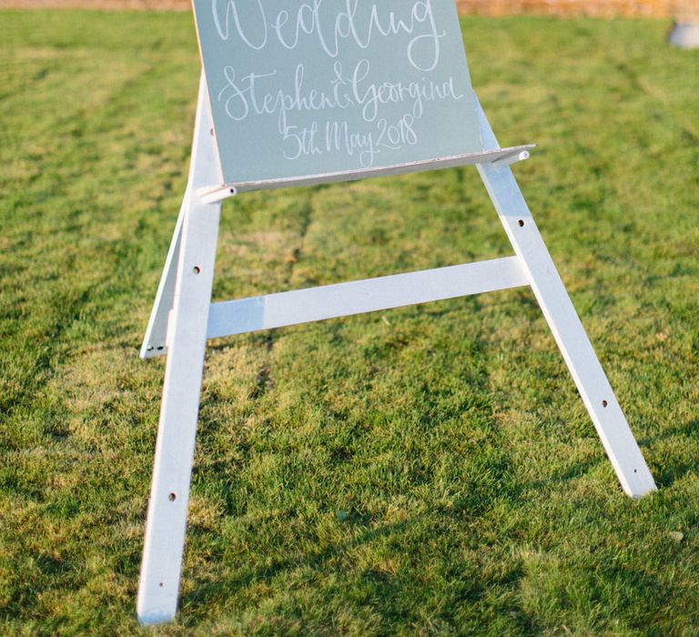 Wooden Signage | Modern calligraphy | Papakata Sperry Tent Wedding at family home | Sassi Holford Dress with added ivory Ostrich feathers to veil | Manolo Blahnik shoes | Images by Melissa Beattie