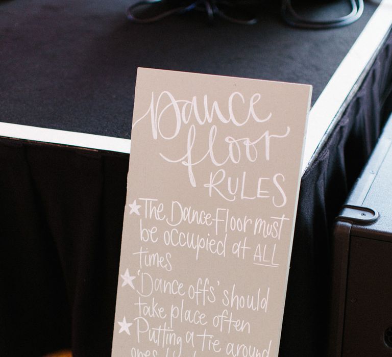 Calligraphy signage | Dance floor rules | Papakata Sperry Tent Wedding at family home | Sassi Holford Dress with added ivory Ostrich feathers to veil | Manolo Blahnik shoes | Images by Melissa Beattie