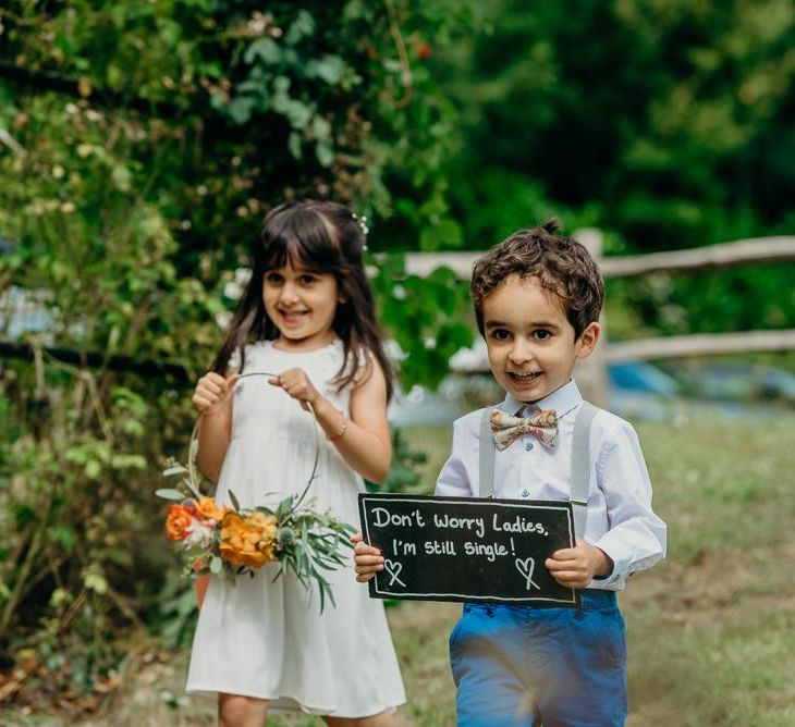 Cute kids at wedding with wedding sign