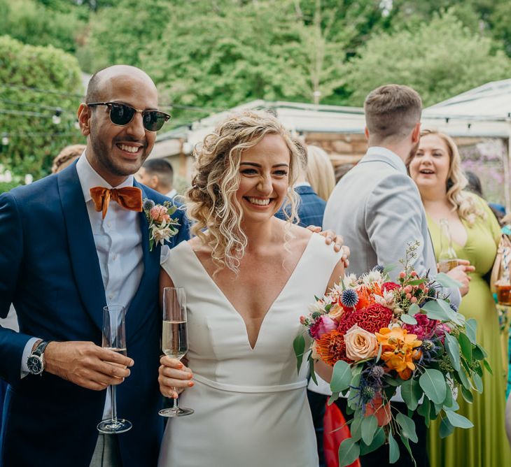 Bride and groom in blue wedding suit with bright bowtie