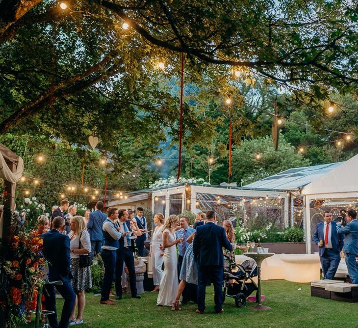 Wedding marquee with festoon lighting and bright wedding decorations