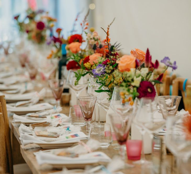 Bright wedding decorations for dinner tables in marquee