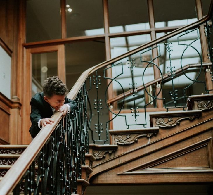 Page boy playing on the stairs