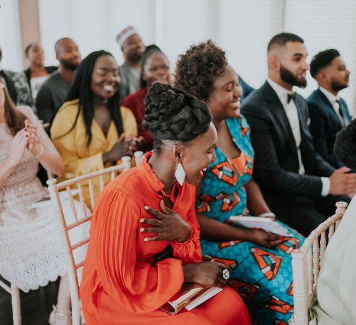 Wedding guests cheering at the wedding ceremony