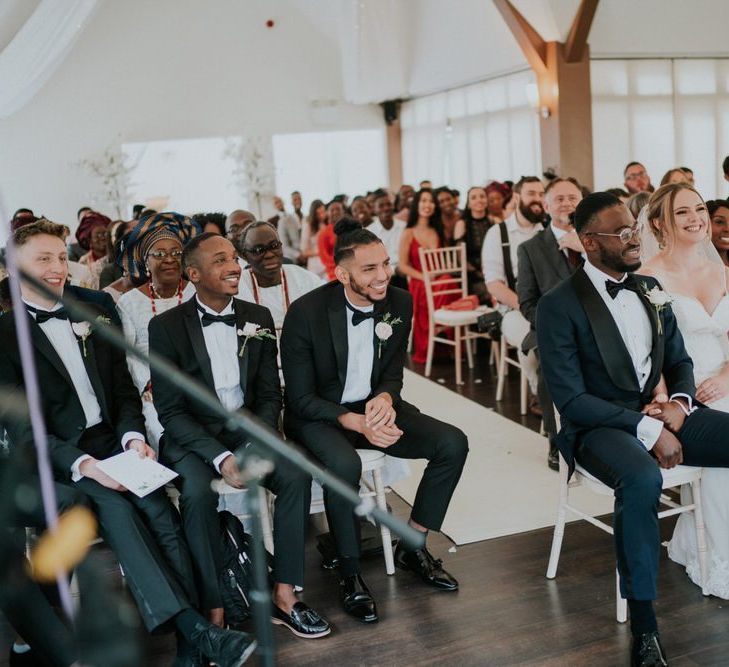 Bride in Morilee wedding dress and groom in tuxedo at wedding ceremony