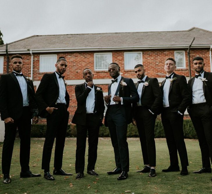 Stylish groomsmen in tuxedos