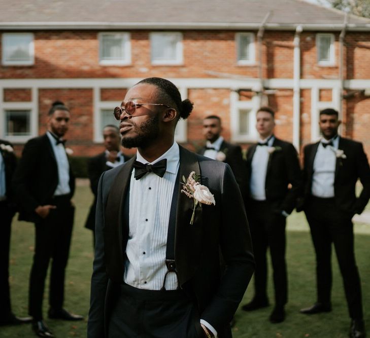 Groom in black tie suit and bow tie