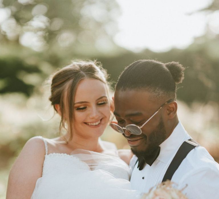 Groom in braces picking up his bride