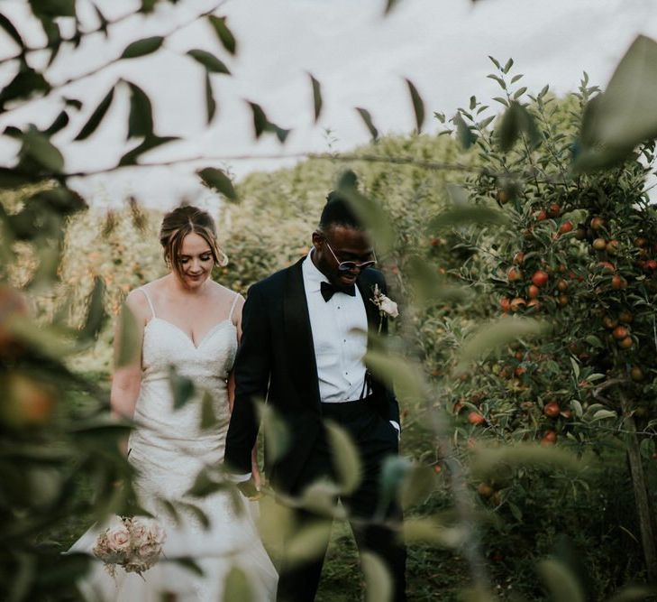 Bride and groom portrait in a field with bride in Morilee wedding dress