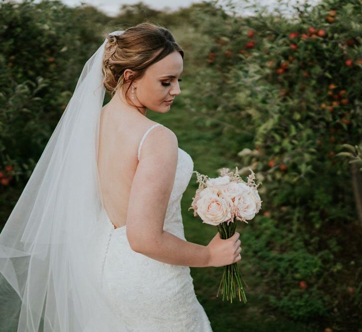 Beautiful bride in a lace Morilee wedding dress