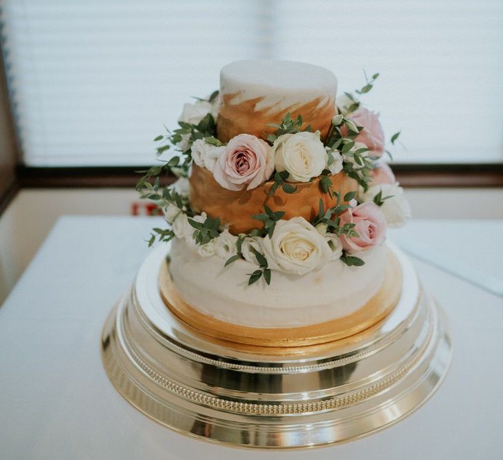 Three tier wedding cake decorated with flowers