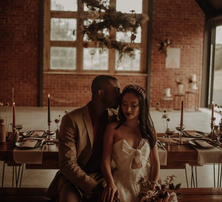 Groom kissing his brides head